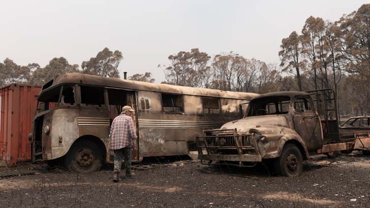 Torrington resident Lee Morgan surveys the damage around her home after the firestorm which tore through her small town, narrowly missing her main residence as she ran for her life. November 11, 2019 in Glen Innes, Australia. Three people have died and 20