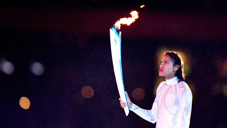 Cathy Freeman of Australia holds the Olympic Torch prior to lighting the Olympic Flame during the Opening Ceremony of the Sydney 2000 Olympic Games at the Olympic Stadium in Homebush Bay, Sydney, Australia. Mandatory Credit: Al Bello /Allsport.